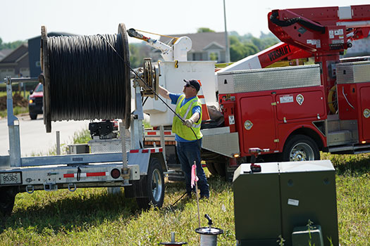 CFU communications tech pulling fiber in residential neighborhood